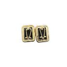 Pair of gold and black earrings on a white background