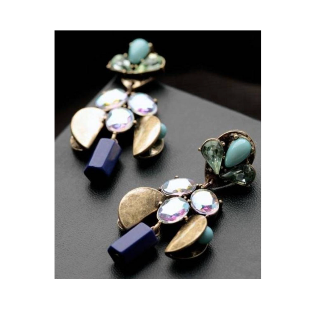 Pair of gold and blue earrings on a dark surface