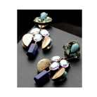 Pair of gold and blue earrings on a dark surface