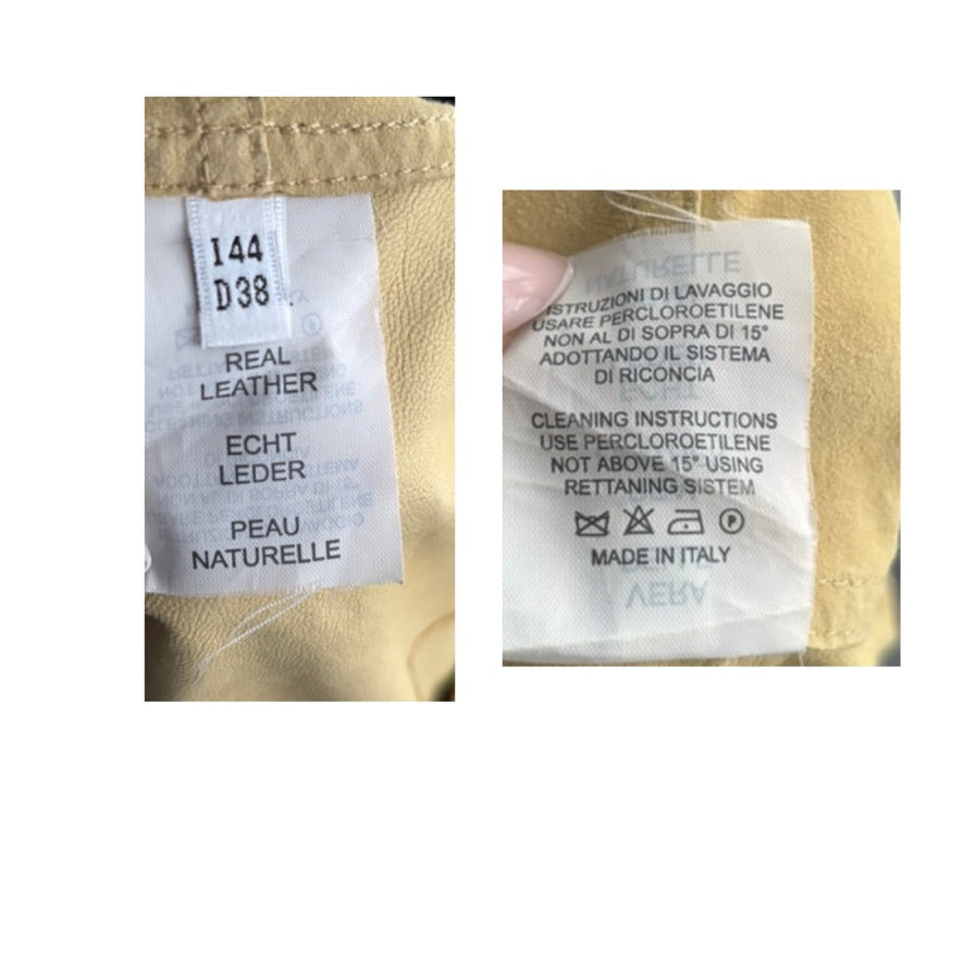 Close-up of leather label with text and symbols on a beige background