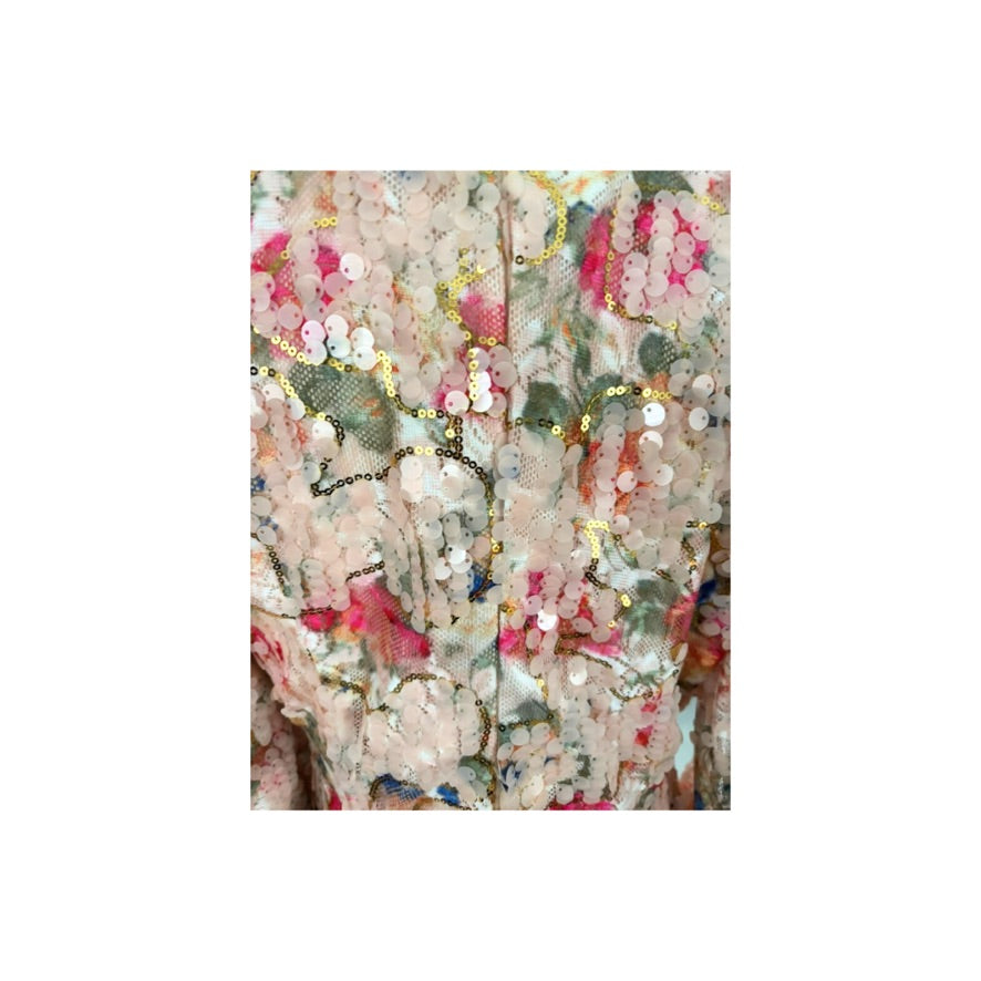Floral fabric with sequins and beads on a white background