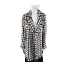 Mannequin wearing a patterned coat on a white background