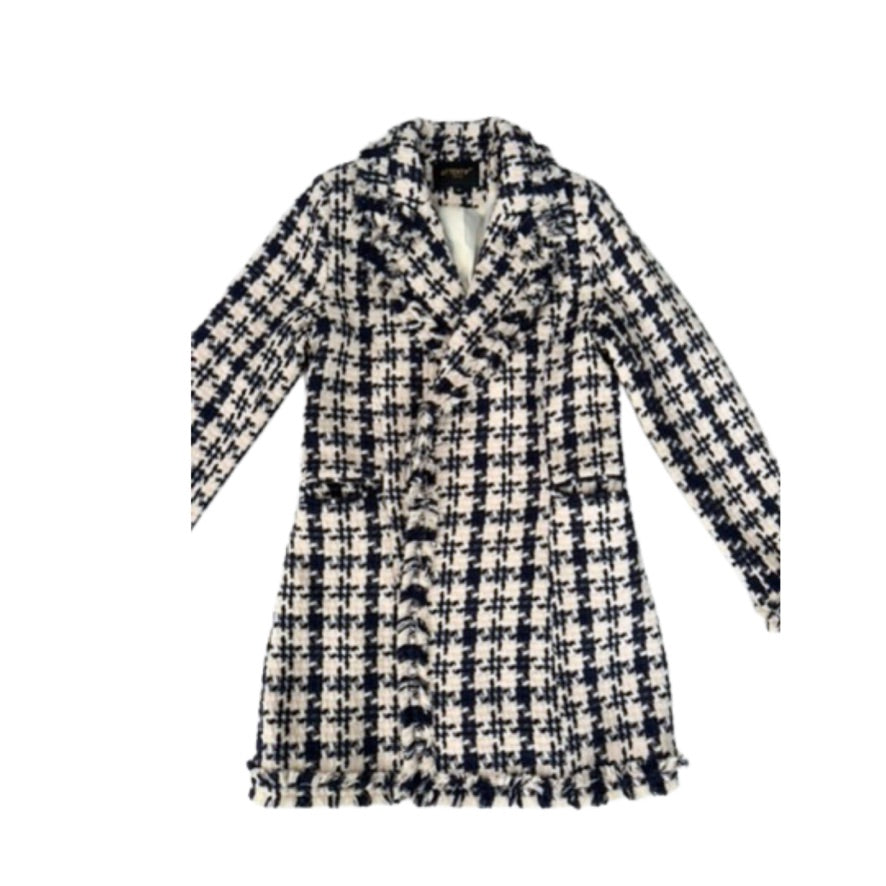 Houndstooth patterned coat on a white background
