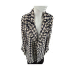 Mannequin wearing a patterned scarf on a white background