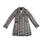 Houndstooth patterned coat on a white background