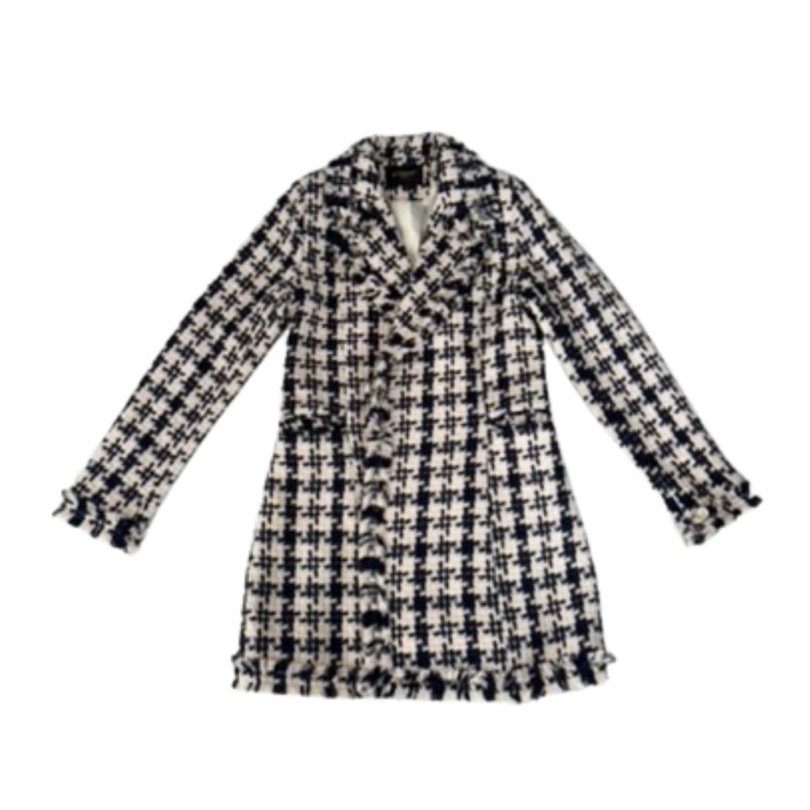 Houndstooth patterned coat on a white background