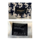 Attentif Paris clothing label with fabric composition details on a white background