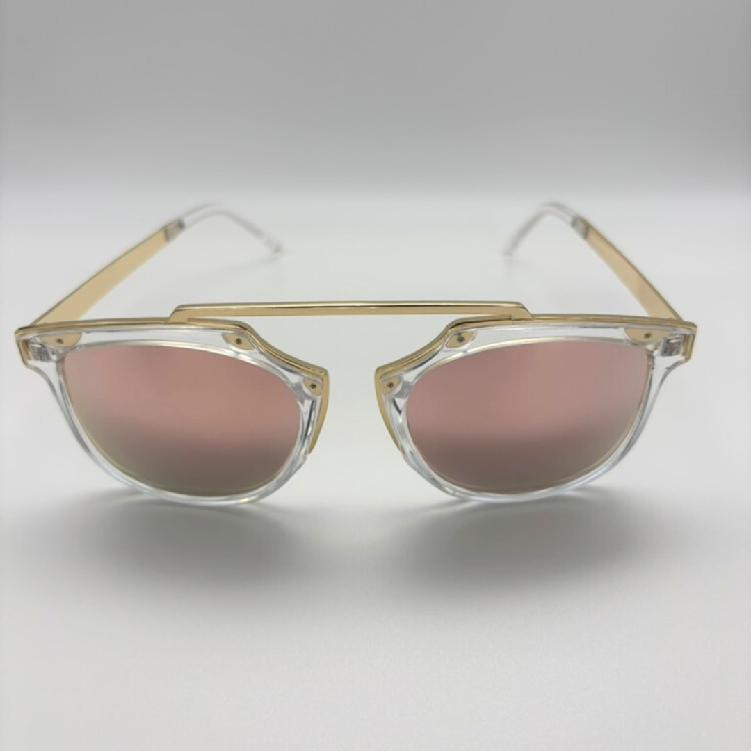 Sunglasses with gold frame and pink lenses on a light gray background