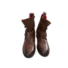 Pair of brown leather boots with red lining on a white background