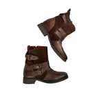 Brown leather boots with buckles on a white background