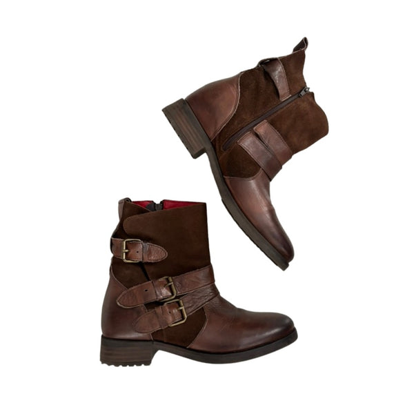Brown leather boots with buckles on a white background