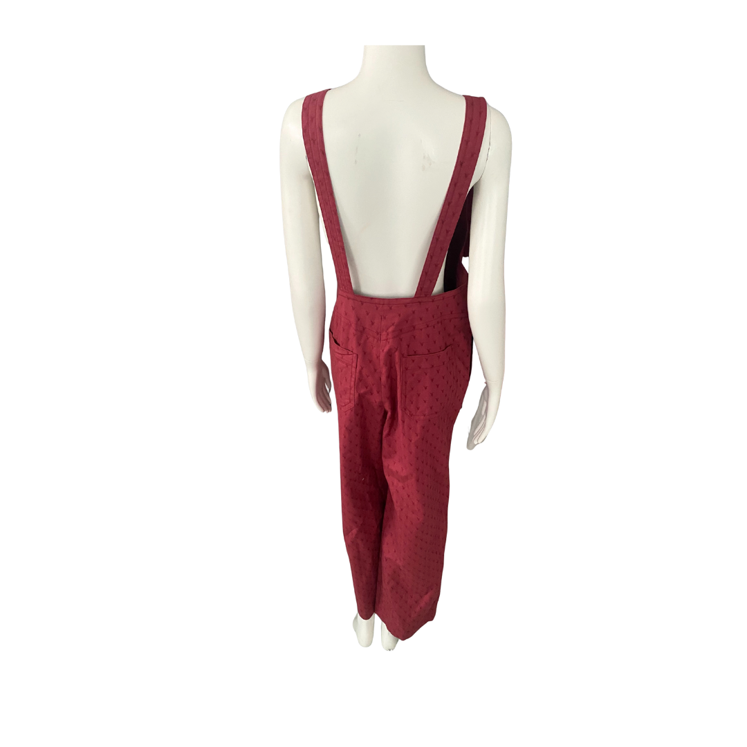 Red overalls on a mannequin against a white background