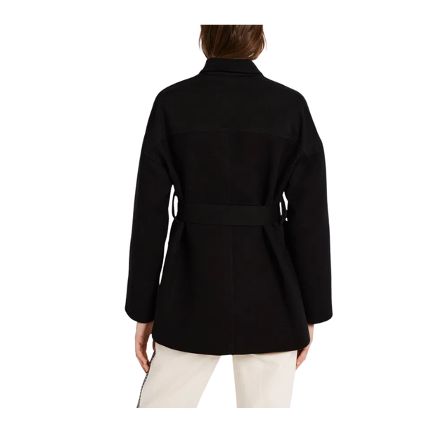 Black coat worn by a person on a white background