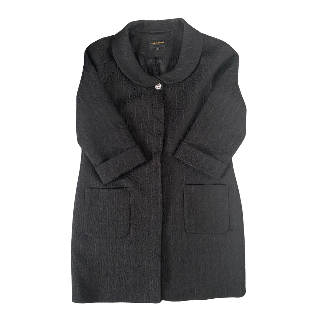 A black brocade coat with a round collar, button front fastening, and cuffed sleeves, displayed on a plain background.