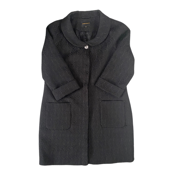 A black brocade coat with a round collar, button front fastening, and cuffed sleeves, displayed on a plain background.