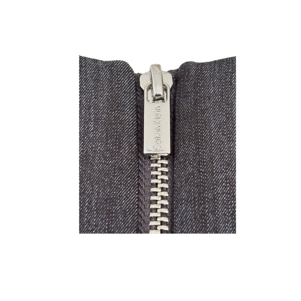 Close-up of a zipper on a gray fabric background