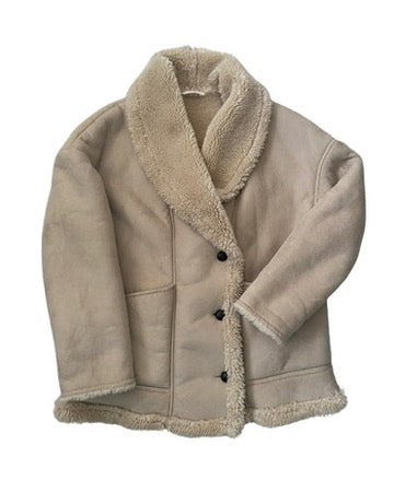 Beige shearling jacket with black buttons on a white background