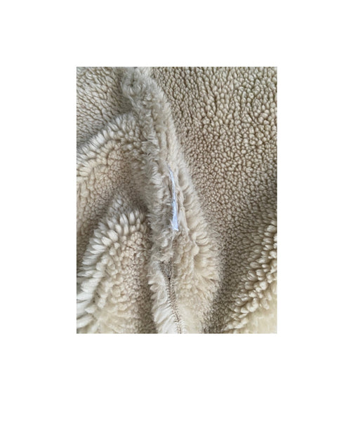 Close-up of textured beige fabric with a white background