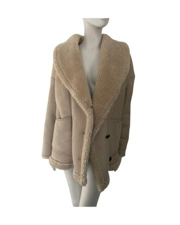 Beige shearling jacket on a mannequin against a white background