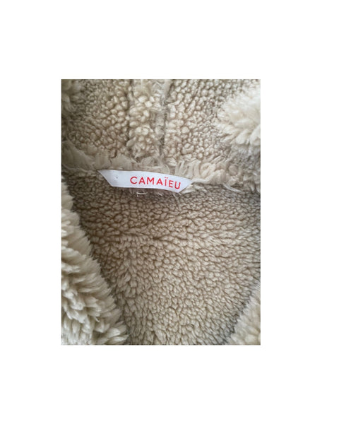 Close-up of textured fabric with a Camaieu label on a white background