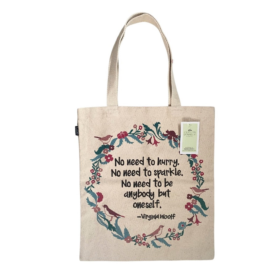 Tote bag with floral design and quote by Virginia Woolf on a white background