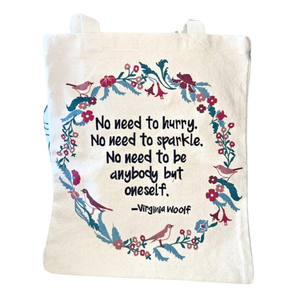 Tote bag with floral design and quote by Virginia Woolf on a white background