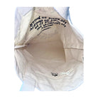 Close-up of a beige bag with text on a white background