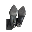 Pair of black high-heeled shoes on a white background