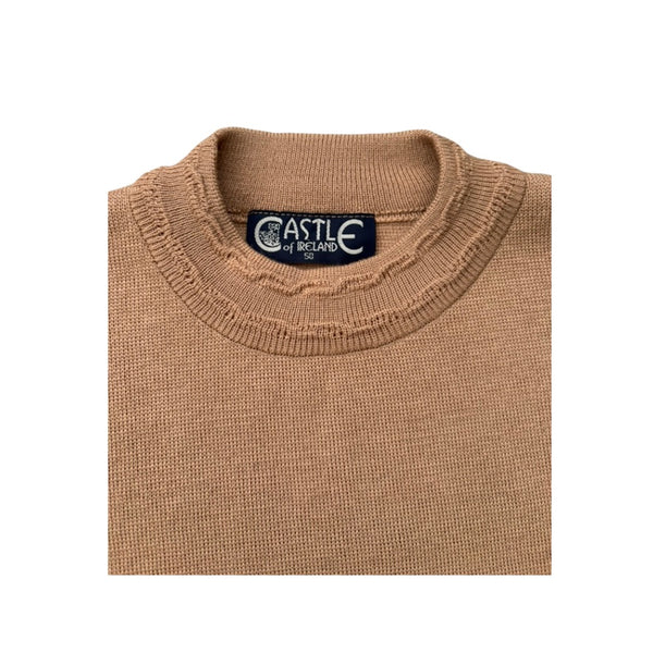 Folded beige sweater with 'Castle of Ireland' label on a white background
