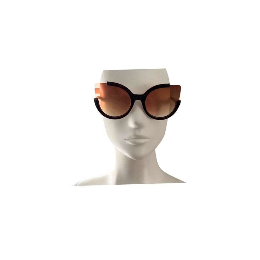 Sunglasses with black frame and brown lenses on a mannequin head against a white background