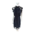 Mannequin wearing a black plaid dress with lace sleeves and hem on a white background