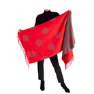 Person holding a red and grey patterned scarf on a white background