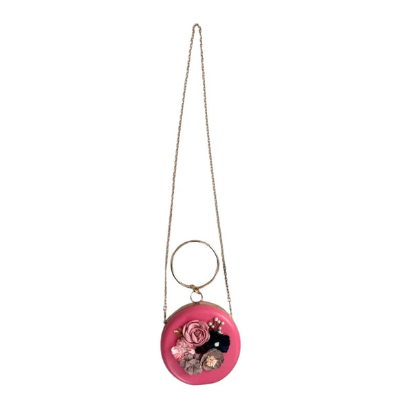 Pink round bag with floral design on a chain against a white background