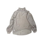 Leopard patterned blouse on a white background