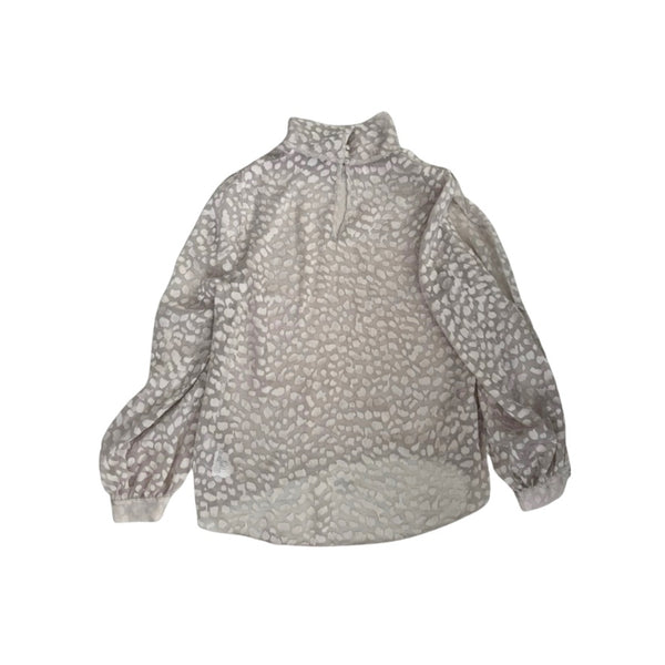 Leopard patterned blouse on a white background