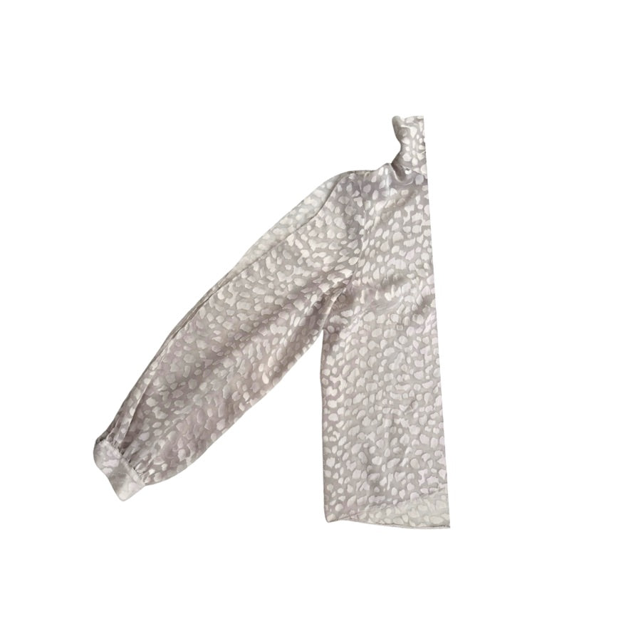 Silky sleeve with a subtle pattern on a white background