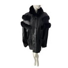 Black leather coat with fur trim on a mannequin against a white background