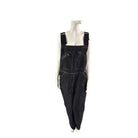 Black overalls on a mannequin against a white background