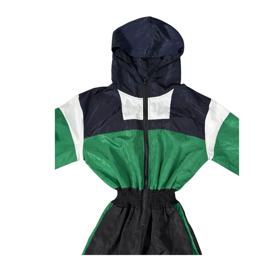Color-blocked raincoat with navy, green, and white sections on a white background