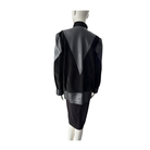 Black and gray jacket on a mannequin against a white background