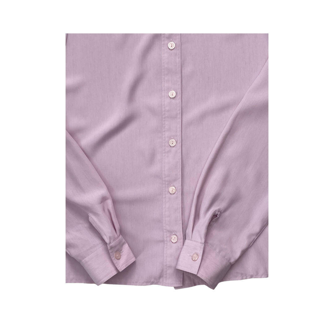 Close-up of a light purple button-up shirt with rolled-up sleeves on a white background