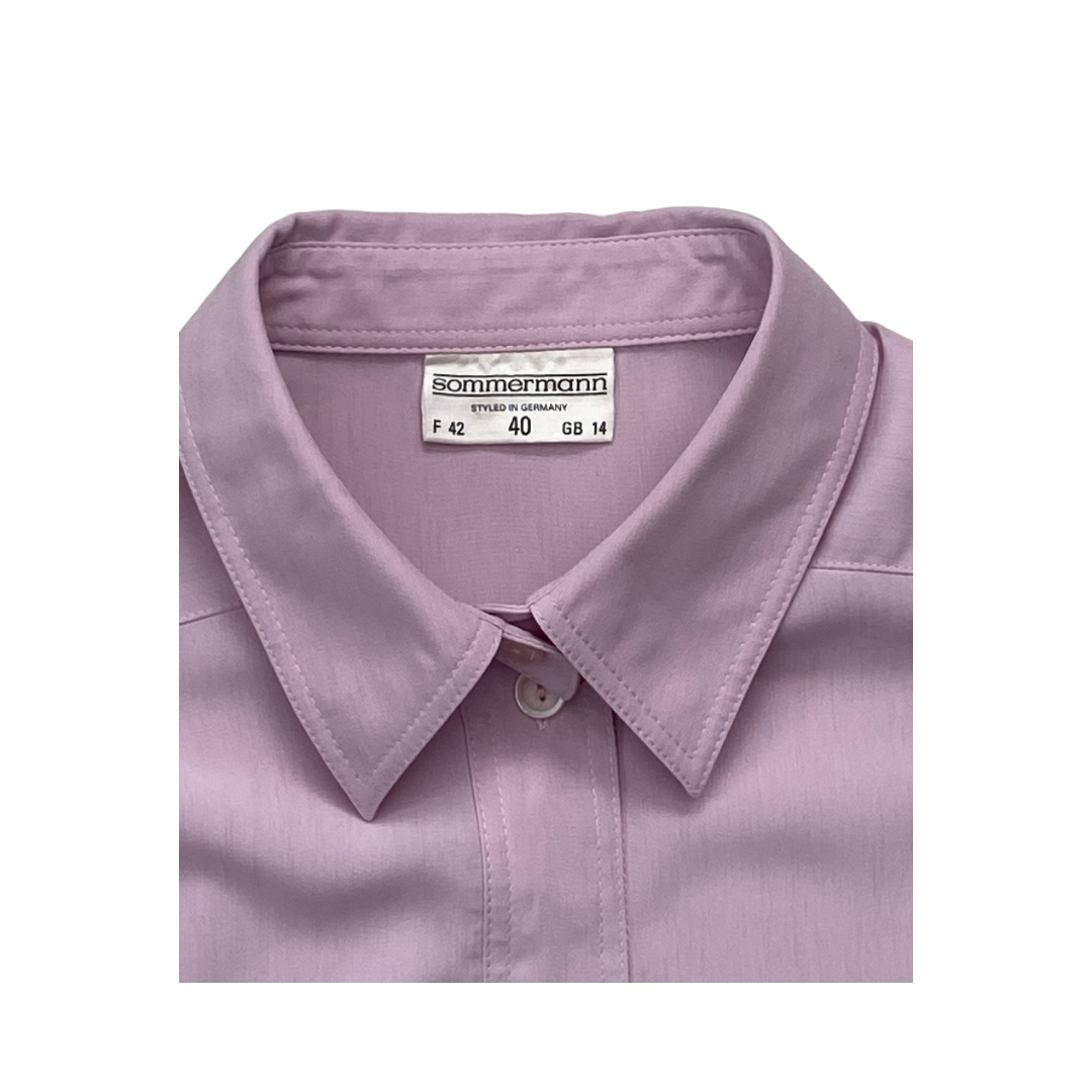 Folded light purple shirt with a Sommerrmann label on a white background