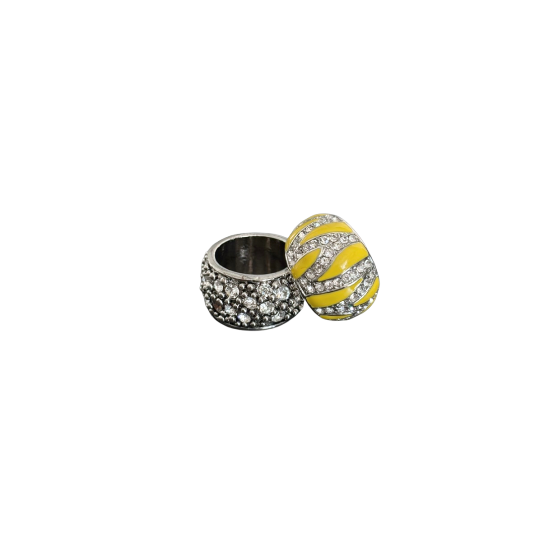 Silver crystal and yellow accent rings on a white background