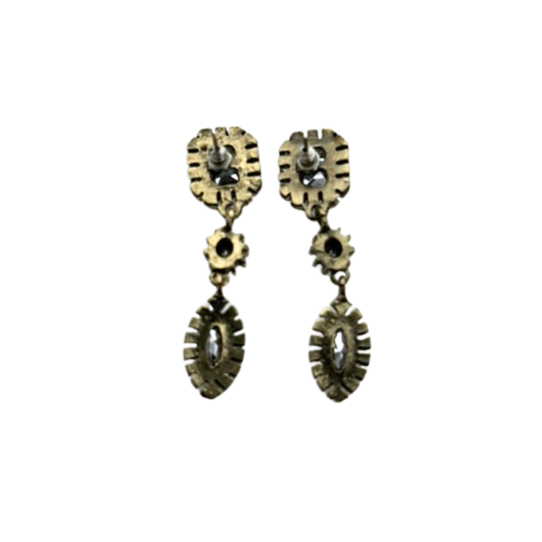 Pair of gold earrings with gemstones on a white background