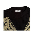 Black sweater with gold embroidery and 'Fast Tram' label on a white background