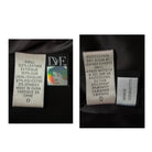 Two clothing labels on a dark fabric background