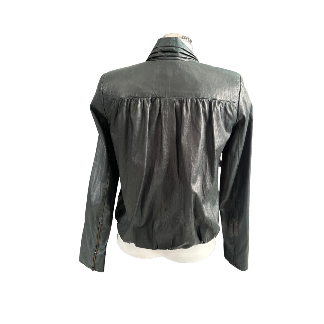 Green leather jacket on a mannequin against a white background