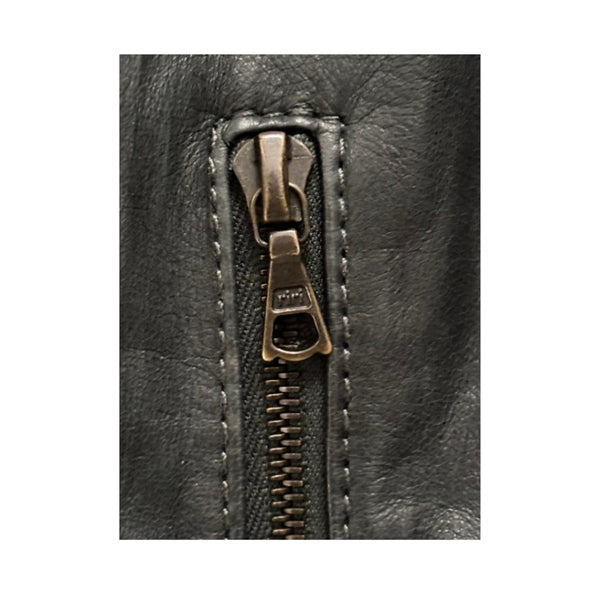 Close-up of a zipper on a black leather jacket