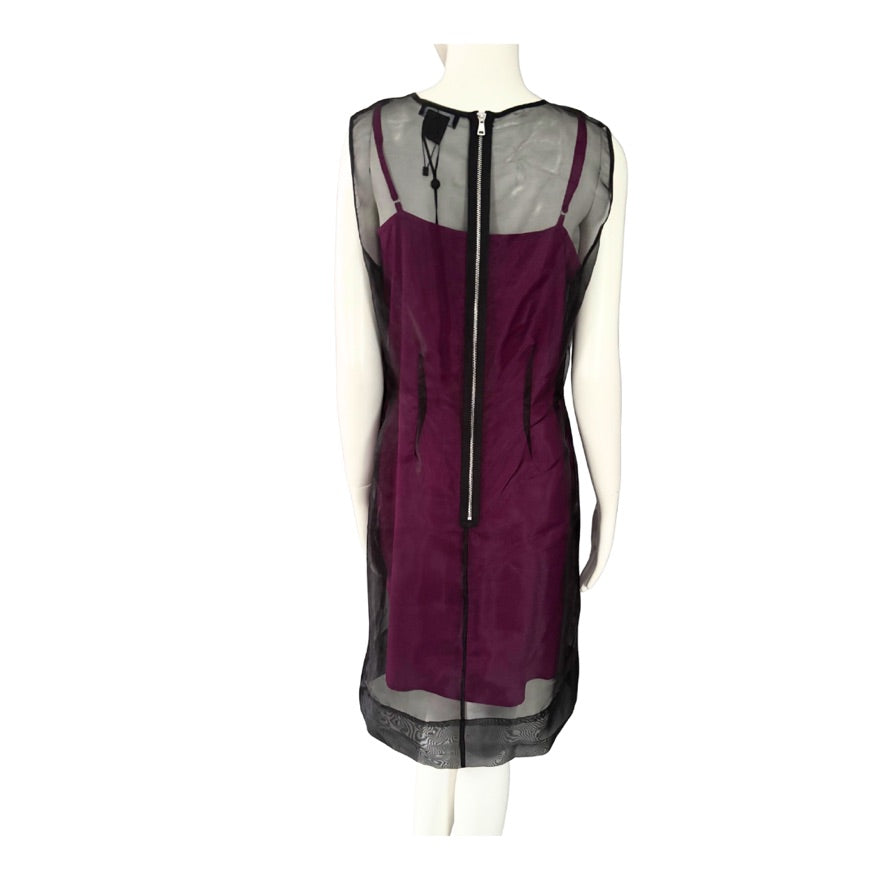 Pink dress with sheer black overlay on a mannequin against a white background