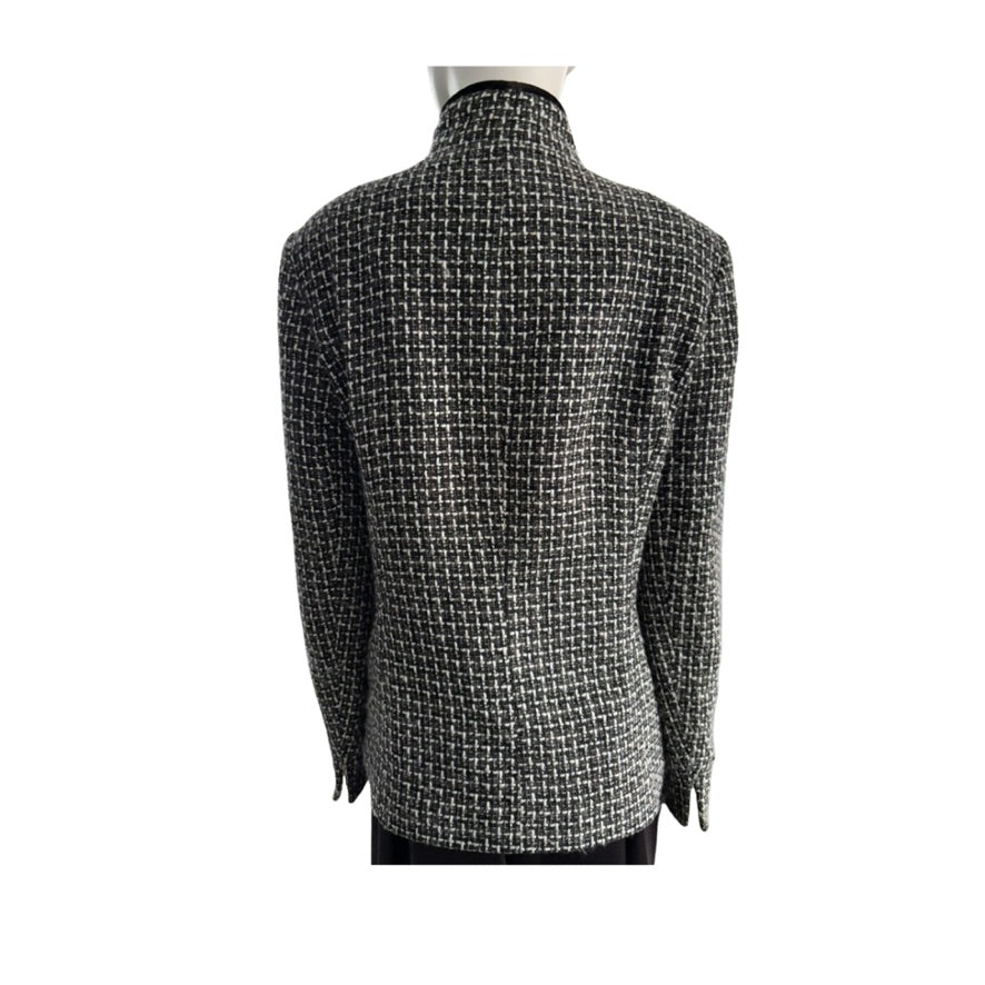 Black and white checkered jacket on a mannequin against a white background